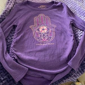 Justice purple thermal pullover with long sleeves and Hamsa design.